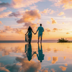 couple watching sunset at infinity pool Saint Lucia, couple on vacation tropical Island of St Lucia with beautiful reflection in pool
