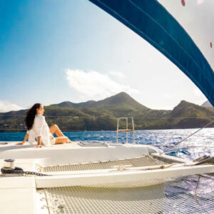 Carefree and Content,a Young Woman Enjoys a Moment of Serene Relaxation on the Deck of a Boat,her Cares Carried Away by the Gentle Breeze amidst the Azure Sky,Embodying the Essence of Vacation Bliss on a Radiant and Sunny Day.